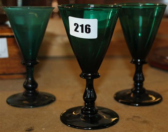 Set of three dark green wine glasses